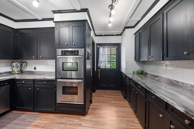 kitchen featuring tasteful backsplash, light hardwood / wood-style flooring, and appliances with stainless steel finishes