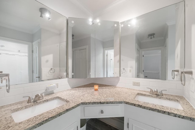 bathroom with vanity, crown molding, and decorative backsplash