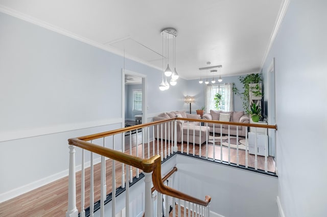 hall with crown molding and light wood-type flooring