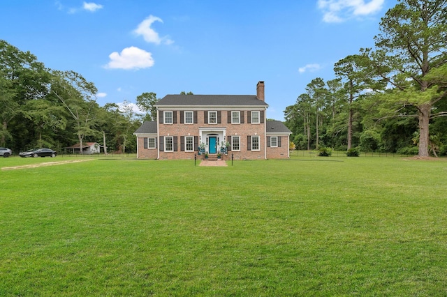 colonial inspired home with a front lawn