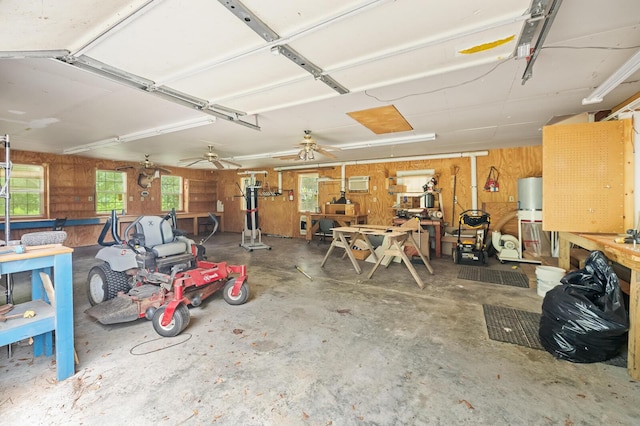 garage with wood walls and a workshop area