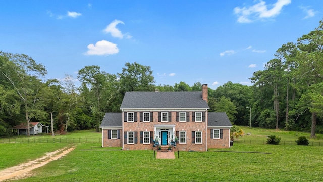 colonial inspired home featuring a front yard