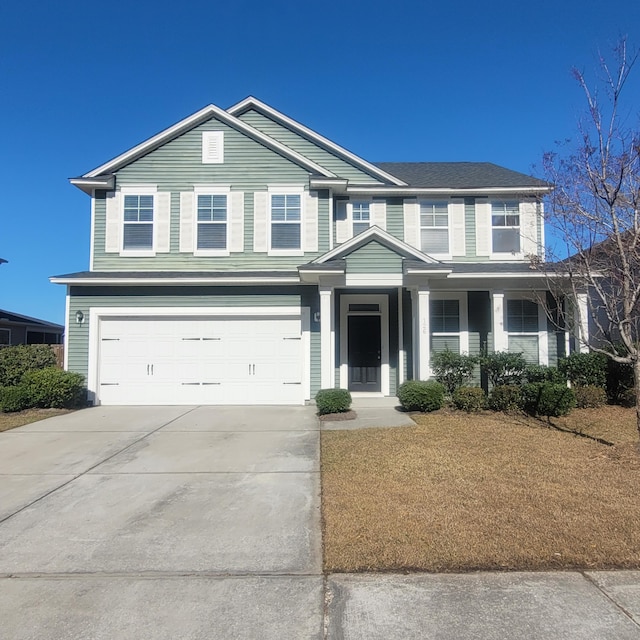 traditional-style house with an attached garage and concrete driveway