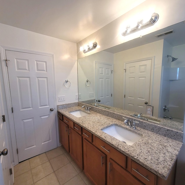 full bath featuring double vanity, visible vents, a sink, and tile patterned floors