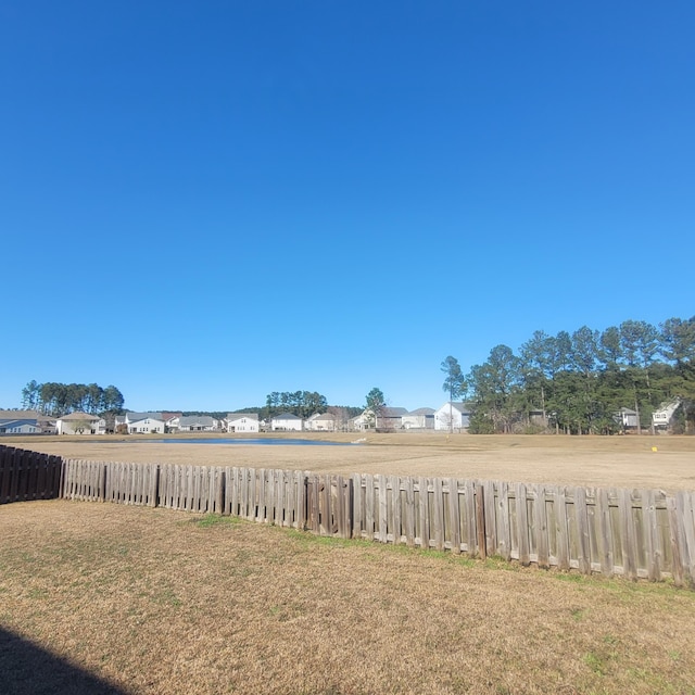 view of yard featuring a residential view and fence