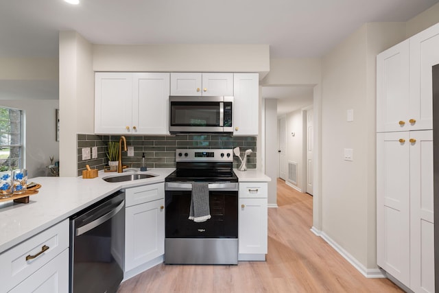 1478 Diamond Blvd, Mount Pleasant, SC 29466 - kitchen with appliances with stainless steel finishes, light wood-style flooring, light countertops, and tasteful backsplash