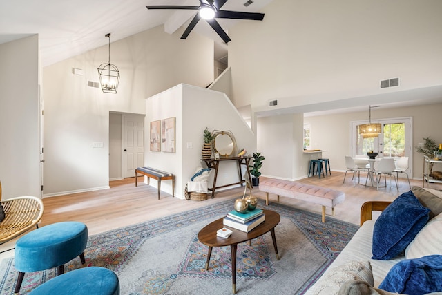 1478 Diamond Blvd, Mount Pleasant, SC 29466 - living room featuring high vaulted ceiling, a ceiling fan, a chandelier, and wood finished floors