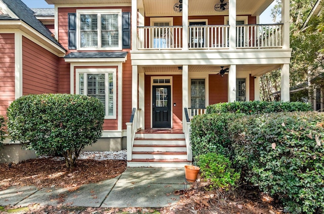 doorway to property with ceiling fan and a balcony