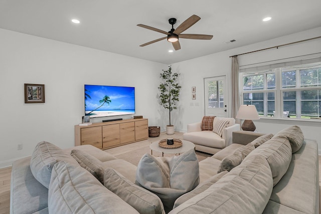 living area featuring ceiling fan, visible vents, light wood-type flooring, baseboards, and recessed lighting