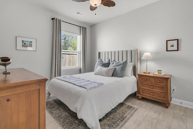 bedroom featuring visible vents, light wood finished floors, ceiling fan, and baseboards