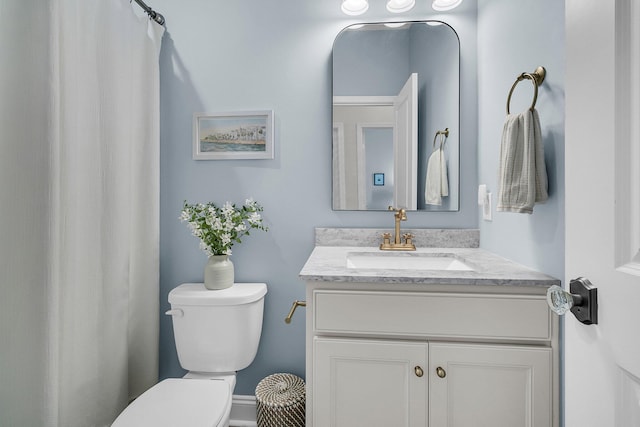 bathroom featuring vanity and toilet