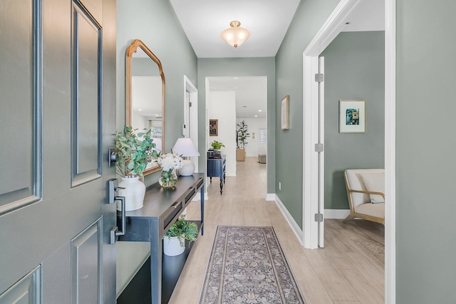 interior space featuring baseboards and light wood-type flooring