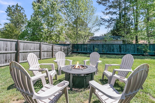 view of yard featuring a fire pit and a fenced backyard
