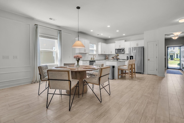 dining room featuring recessed lighting, light wood finished floors, and visible vents