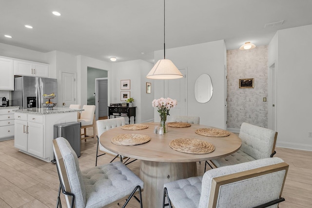 dining area with recessed lighting, baseboards, and light wood-style flooring
