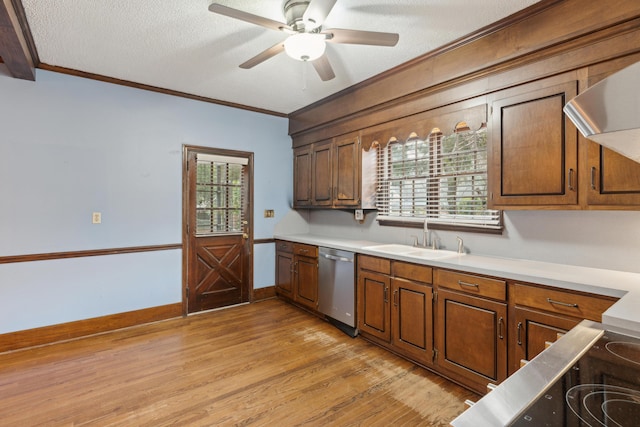 kitchen with light wood-style flooring, a sink, light countertops, crown molding, and stainless steel dishwasher