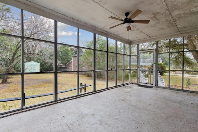 unfurnished sunroom with a ceiling fan