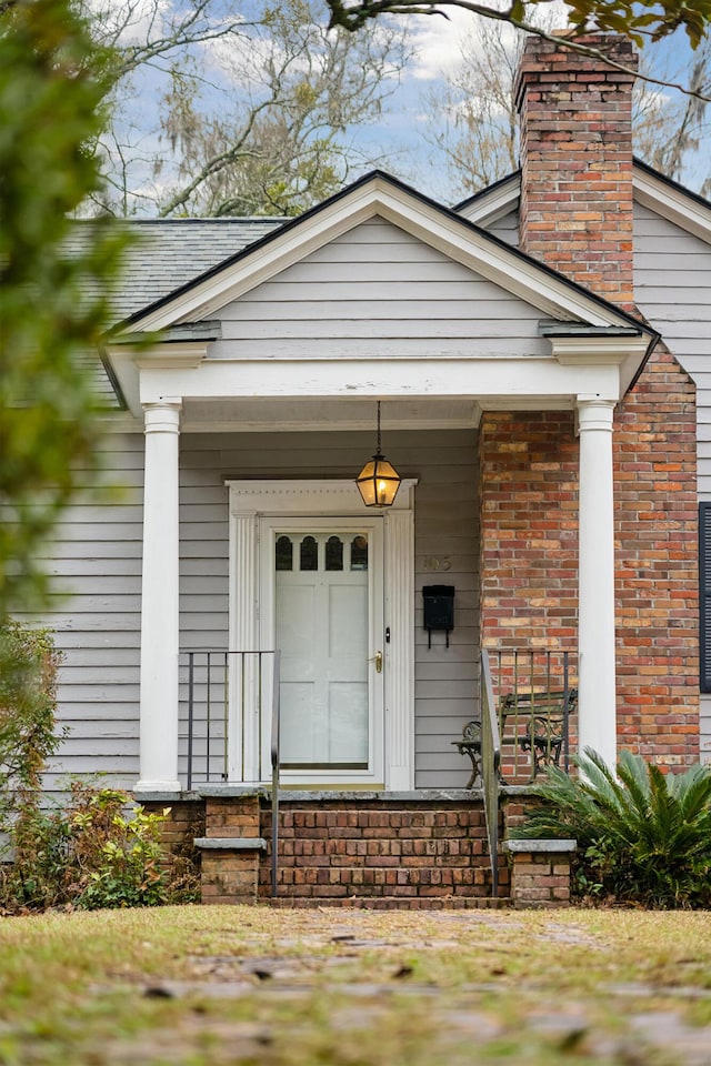 doorway to property with a chimney