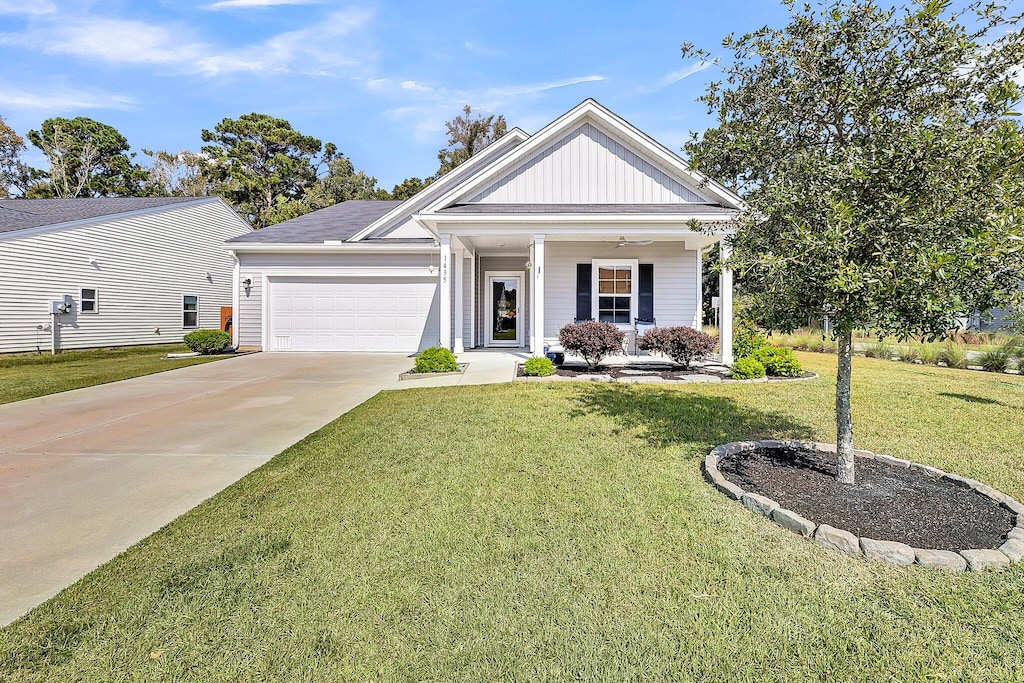 view of front of home with a front yard and a garage