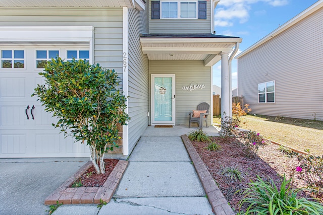 property entrance featuring covered porch and an attached garage