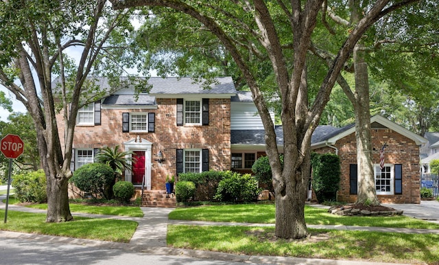 1067 Loyalist Ln, Mount Pleasant, SC 29464 - view of front of home featuring brick siding, roof with shingles, and a front yard