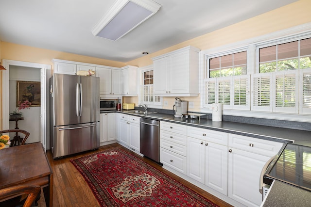 1067 Loyalist Ln, Mount Pleasant, SC 29464 - kitchen with stainless steel appliances, dark countertops, and white cabinetry