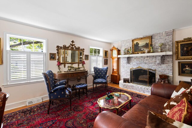 1067 Loyalist Ln, Mount Pleasant, SC 29464 - living room with wood finished floors, a brick fireplace, and ornamental molding