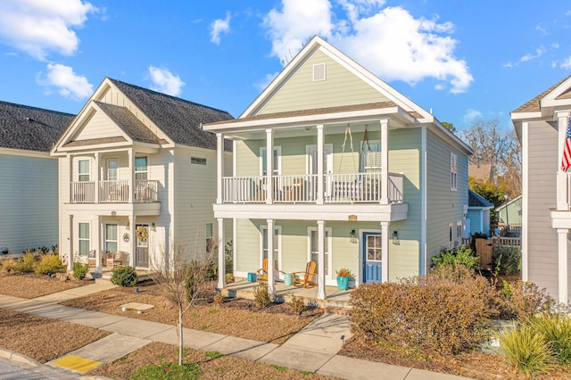 view of front of house featuring a balcony and covered porch