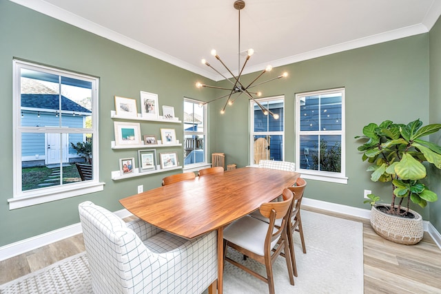 dining room with crown molding, light hardwood / wood-style flooring, and a chandelier