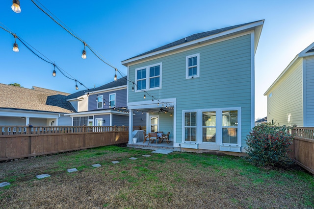 back of house featuring a yard and a patio area