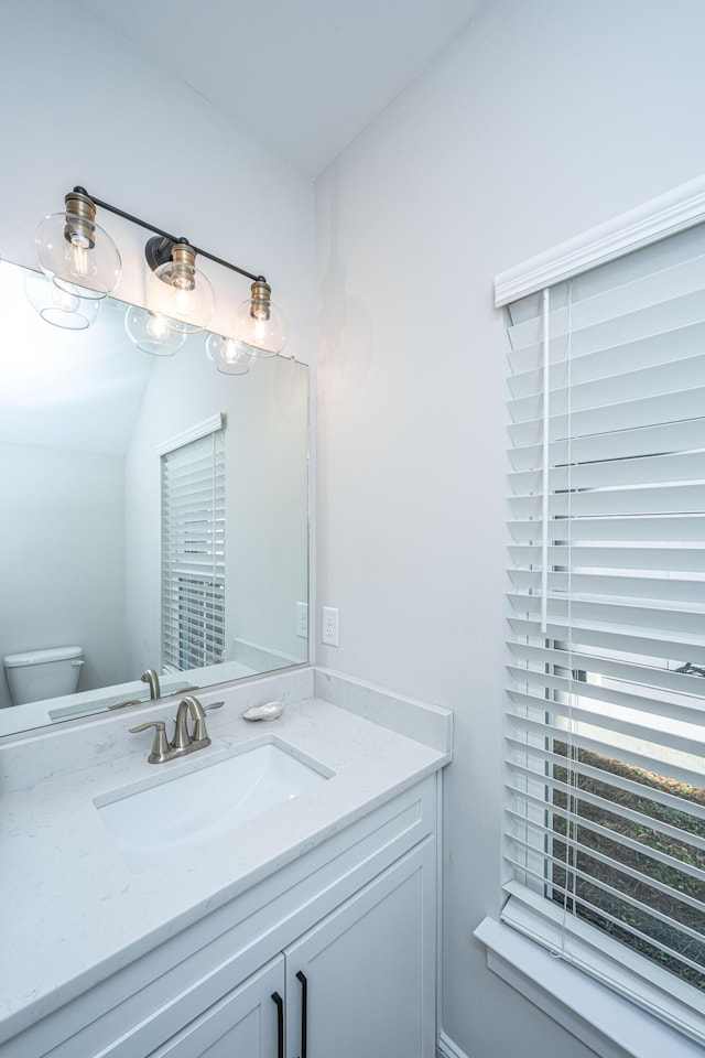 bathroom featuring vanity and toilet