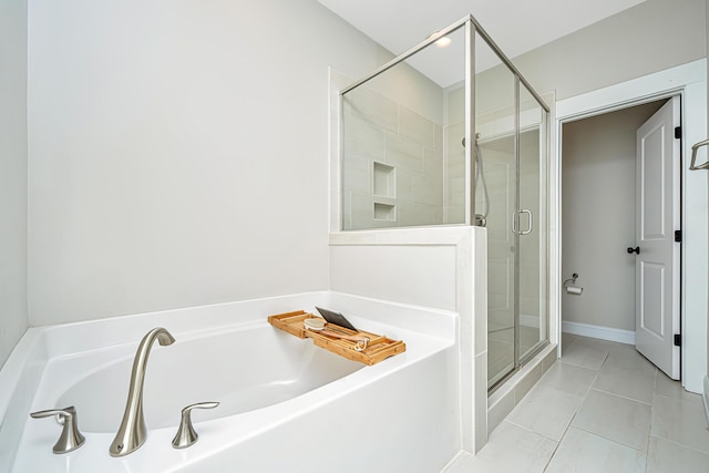 bathroom with tile patterned flooring and separate shower and tub