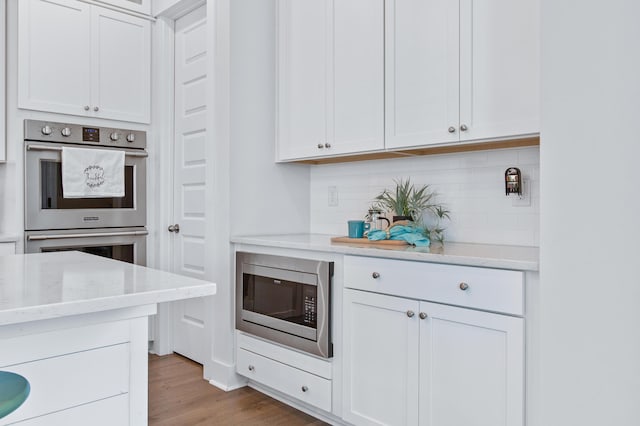 840 Forrest Dr, Charleston, SC 29492 - kitchen with stainless steel appliances, backsplash, and white cabinets