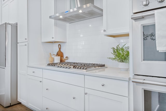 840 Forrest Dr, Charleston, SC 29492 - kitchen featuring exhaust hood, appliances with stainless steel finishes, backsplash, and white cabinetry