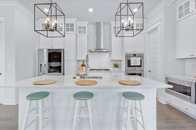 840 Forrest Dr, Charleston, SC 29492 - kitchen featuring a chandelier, appliances with stainless steel finishes, wall chimney range hood, light countertops, and recessed lighting