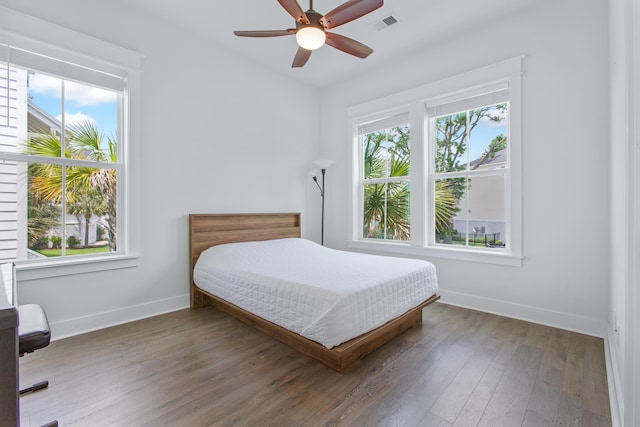 840 Forrest Dr, Charleston, SC 29492 - bedroom featuring multiple windows, baseboards, and wood finished floors