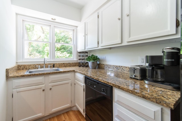 kitchen featuring dishwasher, a sink, light wood-type flooring, and white cabinetry