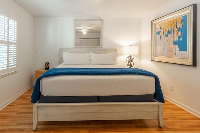 bedroom with baseboards and wood finished floors