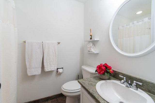 full bath featuring toilet and vanity