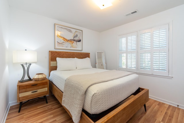 bedroom featuring light wood-style flooring and baseboards