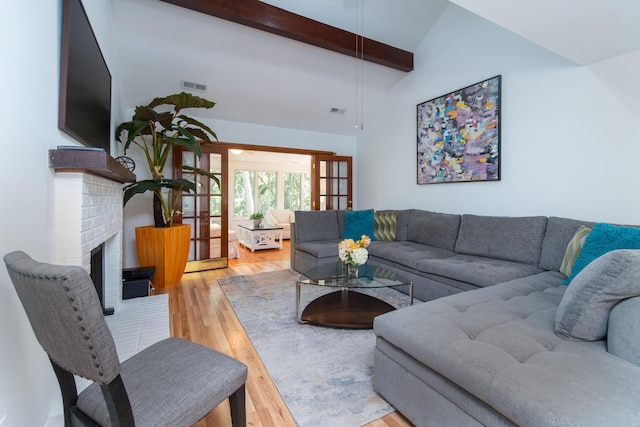 living room featuring wood finished floors and a brick fireplace