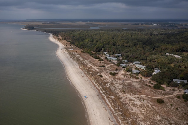 aerial overview of property's location with a heavily wooded area and a nearby body of water