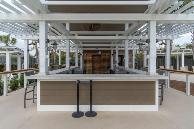 view of patio with a pergola and fence