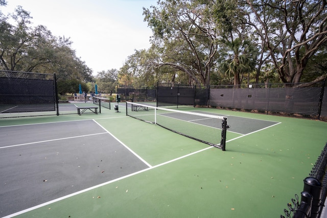 view of tennis court featuring fence