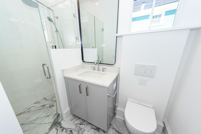 bathroom featuring vanity, a shower with shower door, and toilet