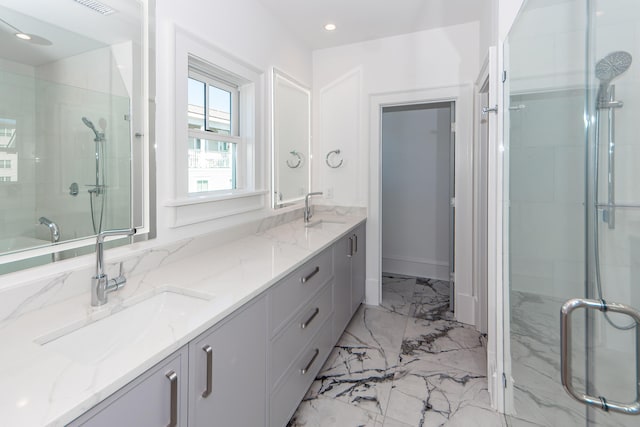 bathroom with vanity and a shower with shower door