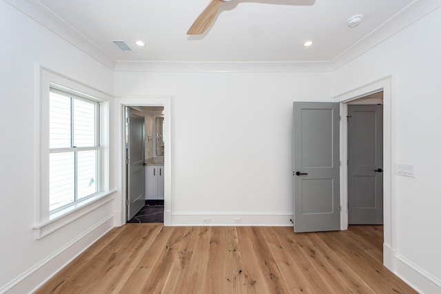 unfurnished bedroom with ceiling fan, crown molding, and light wood-type flooring