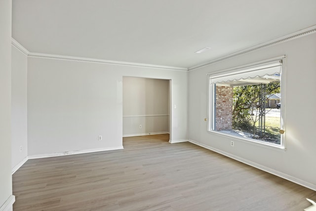 unfurnished room with ornamental molding and light hardwood / wood-style flooring