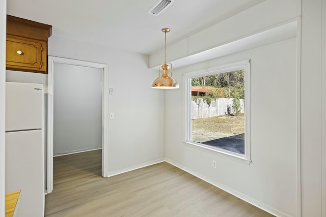 unfurnished dining area with light hardwood / wood-style floors