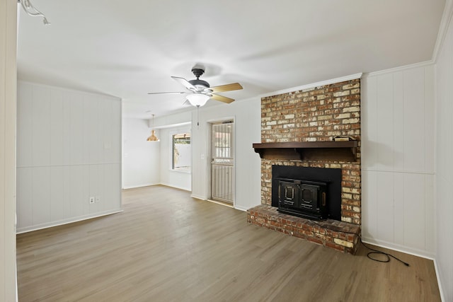 unfurnished living room with crown molding, wood-type flooring, and ceiling fan